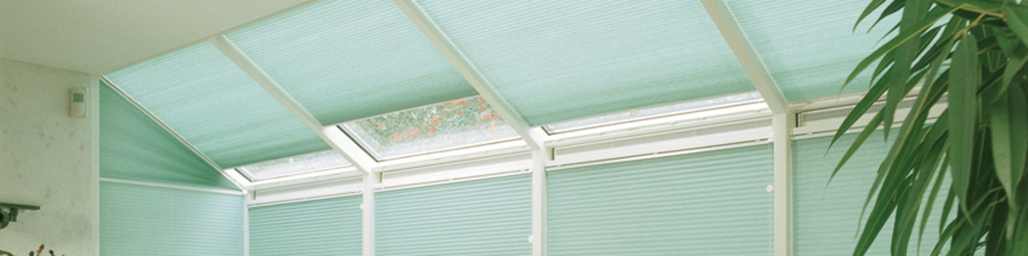 Duette Blinds, like these blue ones hung in a conservatory, are able to help you save energy. Find out more at Blind Revolution.